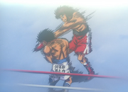 Volg hits Ippo with the White Fang in round two