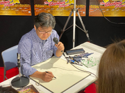 Morikawa doing live drawing at Art Exhibit