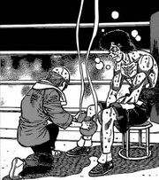 Kamogawa placing ice bags on Takamura's right leg