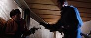 Bond shoots a henchman and moves in to take his gun.
