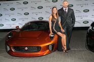 Dave Bautista and his wife alongside the Jaguar used in the film.