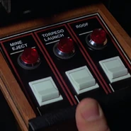 Image of weapon firing controls (left of steering wheel).