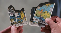 Bond inspecting the burnt Tarot Cards.