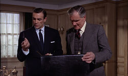 JBondQLookingAtAttacheCaseKnife