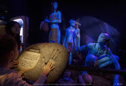 Picture from the exhibit featuring Na'vi and a display of a Na'vi handprint