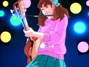 Laura playing her guitar at Jem's concert.