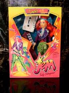 Second edition Kimber with headband, purple jacket, green pants, earrings, shoes, dark pink plastic keytar, hair pick and cassette tape from Hasbro.