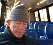 Old man on bus sleeping