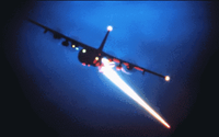 An AC-130 gunship firing its weapons during a night mission.