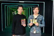 Kikuchi and Ryuta Ueda holding copies of Jet Set Radio Future, Jet Set Radio, and De La Jet Set Radio.