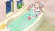 Airi taking a bath even with her magical suit on.