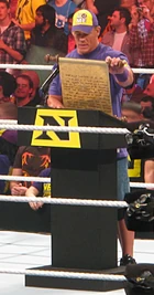 Cena being forced to read a public address by  while a member of  in 2010