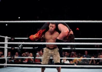 Cena performing his finishing move, a  known as the "Attitude Adjustment", on 