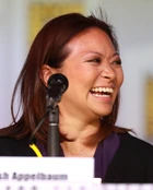 Adele Lim smiles, looking right.