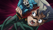 Koichi is attacked in the face by Sheer Heart Attack.