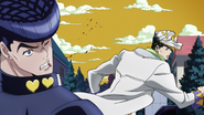 Jotaro punches Josuke in the face.