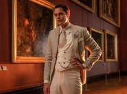 Marquis donned in a beige coat with a white vest underneath.