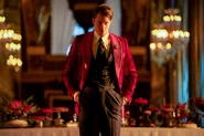 Vincent donned in a red suit with a black vest underneath.