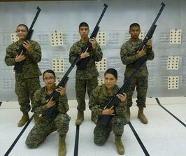 MCJROTC cadets holding air rifles