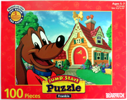 The cover of a jigsaw puzzle featuring Frankie the dog standing in front of his house