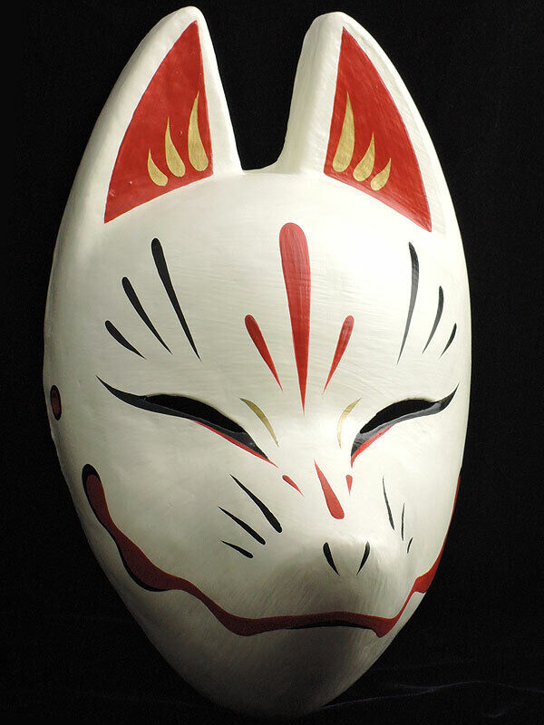 Side shot of a young man wearing a white japanese kitsune fox mask
