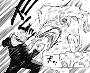 Yuji punching a curse with cursed energy.