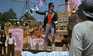 Terminus selling snake-oil from his wagon in the film.