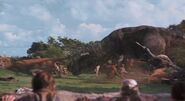 Dr. Grant, Lex, and Tim watch the T. rex jumps in to kill one of the Gallimimus