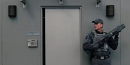 The ACU Guard outside the command center right before Masrani and Vivian go out the door.