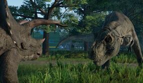 A Tyrannosaurus and a Triceratops in Jurassic World: Evolution.