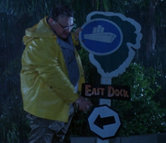 Dennis tries to revert the sign after his Jeep crashes into it.