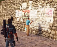 A guy removing graffiti and posters at a Liberated town.