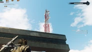 Antenna sitting on top of the bigger building.