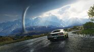 Muscle car driving close to a tornado.