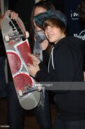 Justin Bieber signing skateboard