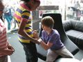 Justin Bieber sigining fan's shirt in London