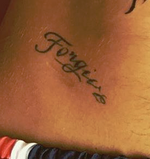 Scar under forgive tattoo