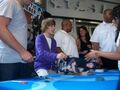 Justin signing posters at Nintendo World Store