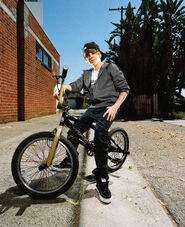 Justin Bieber posing with a bike