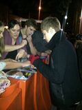 Justin autographing fan's stuff