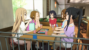 The club members discuss vacation plans at a fast food restaurant.