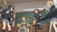 Ritsu making music with her friends.