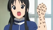 Mio gets mad at Ritsu and the others for drawing on her.