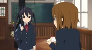 Azusa visibly upset after Yui takes back the cake.