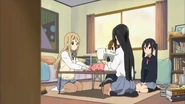 Mio and Tsumugi do Ritsu's homework for her.