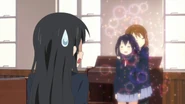 Yui calms Azusa down by petting her.