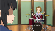 Mio's reaction at Ritsu's newfound excitement to practice