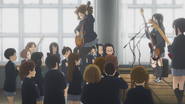 Yui jumping from the stage during the secret concert at school.