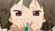 Jun tries to squeeze out the last bit of toothpaste