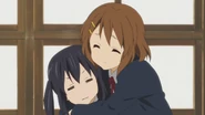 Azuza being hugged by Ui (disguised as Yui).